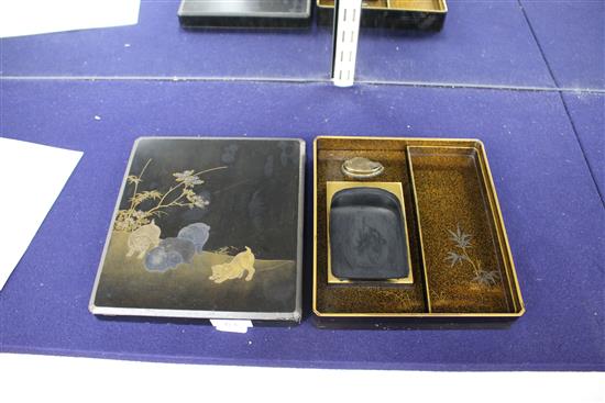 A Japanese Meiji lacquer writing box, the lid decorated with five puppies playing in a garden, underside of the lid with bird perched b